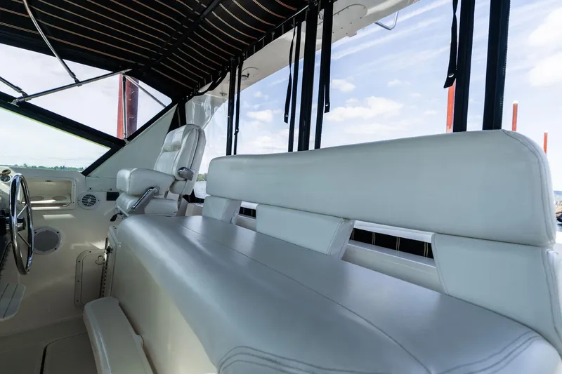 Slide: The Image of 1998 Tiara Yachts 3500 Express interior with white seating and steering wheel. - 40