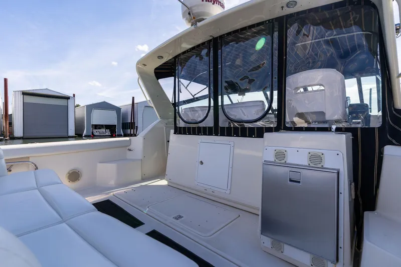 Slide: The Image of 1998 Tiara Yachts 3500 Express boat interior with seating and storage compartments. - 43