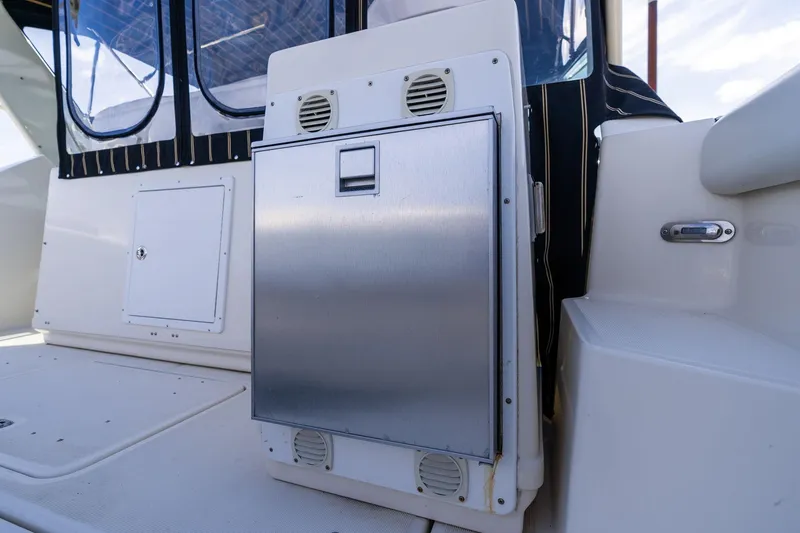 Slide: The Image of 1998 Tiara Yachts 3500 Express interior with stainless steel panel and seating area. - 44