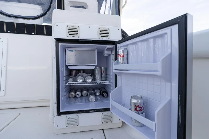 Slide: The Image of Open mini fridge on 1998 Tiara Yachts 3500 Express, stocked with beverages. - 45