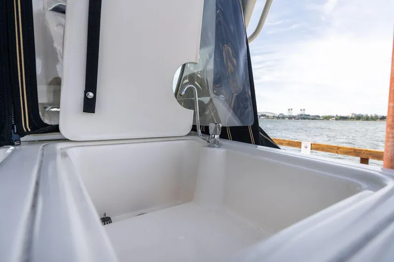 Slide: The Image of 1998 Tiara Yachts 3500 Express sink area with water view in background. - 46