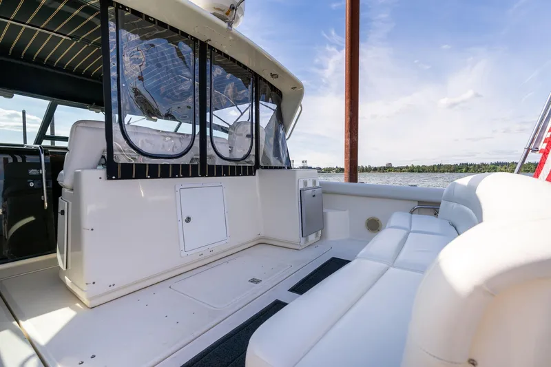 Slide: The Image of 1998 Tiara Yachts 3500 Express boat interior with seating and water view. - 5