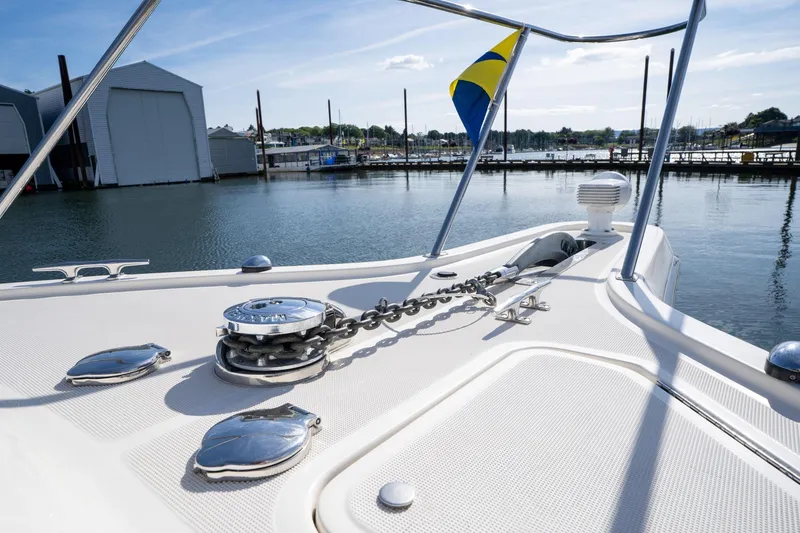 Slide: The Image of Bow of 1998 Tiara Yachts 3500 Express with anchor chain and flag in marina. - 51