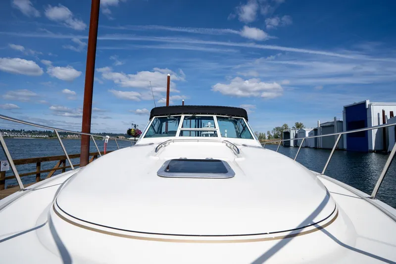 Slide: The Image of 1998 Tiara Yachts 3500 Express docked under a clear blue sky. - 52