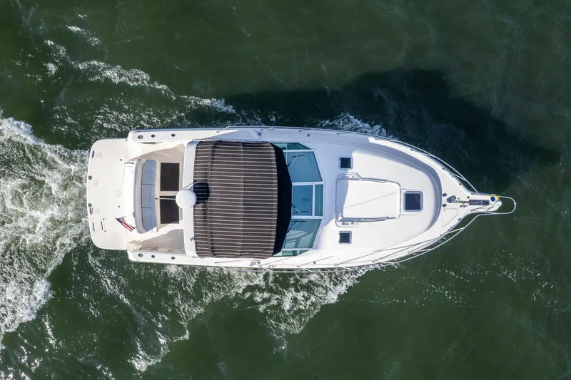 Slide: The Image of Overhead view of 1998 Tiara Yachts 3500 Express cruising on water. - 53
