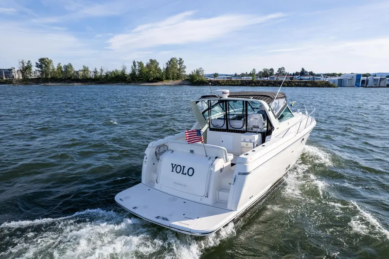 Slide: The Image of 1998 Tiara Yachts 3500 Express cruising on a scenic waterway. - 55