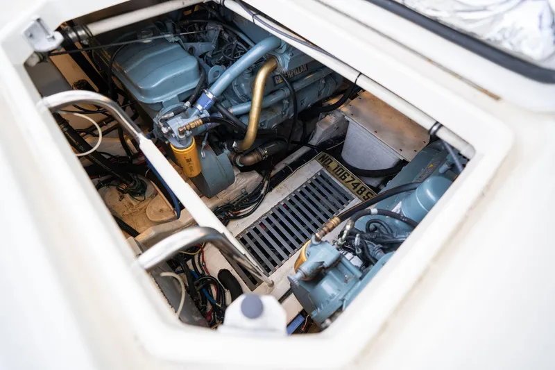 Slide: The Image of Engine compartment of a 1998 Tiara Yachts 3500 Express, showcasing dual engines and mechanical components. - 67