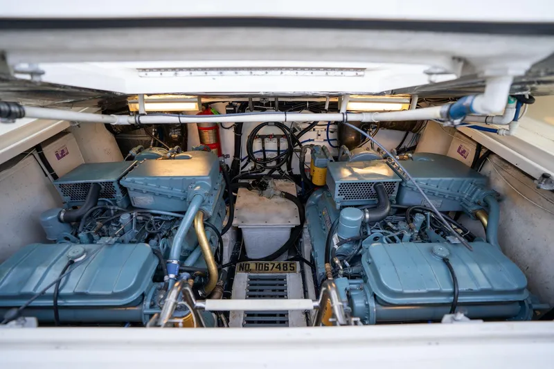 Slide: The Image of Engine compartment of a 1998 Tiara Yachts 3500 Express, showcasing dual engines and mechanical components. - 68