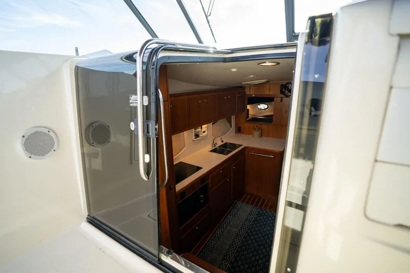 Slide: The Image of Interior view of 1998 Tiara Yachts 3500 Express, showcasing a compact kitchen area. - 7