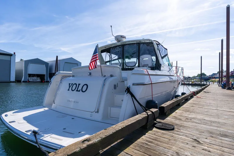 Slide: The Image of 1998 Tiara Yachts 3500 Express docked, displaying "YOLO" and American flag. - 78