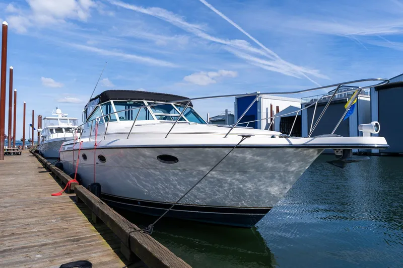 Slide: The Image of 1998 Tiara Yachts 3500 Express docked at marina under blue sky. - 79