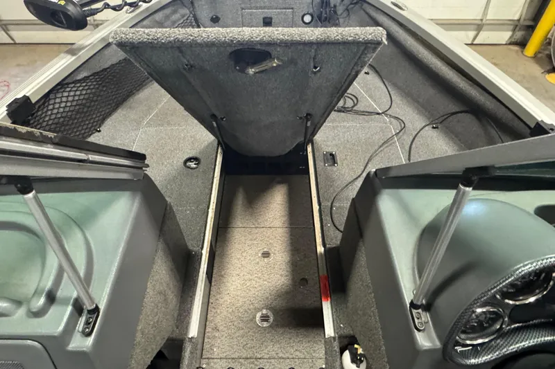 Slide: The Image of 2013 Alumacraft Competitor 175 Sport boat interior with open storage compartments. - 13