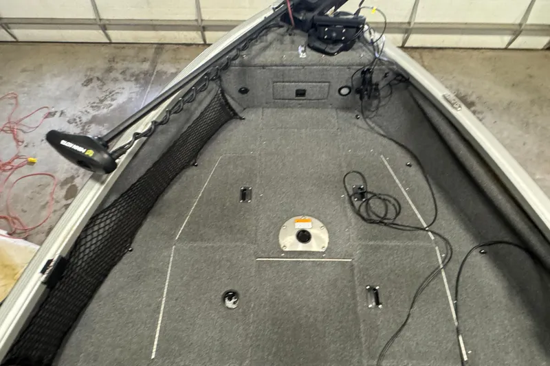 Slide: The Image of Interior view of a 2013 Alumacraft Competitor 175 Sport boat, featuring a carpeted deck. - 14