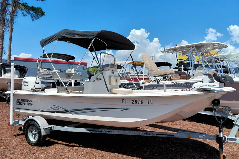 The Image of 2017 Carolina Skiff 18 JVX CC boat on trailer with canopy, parked outdoors. - 1