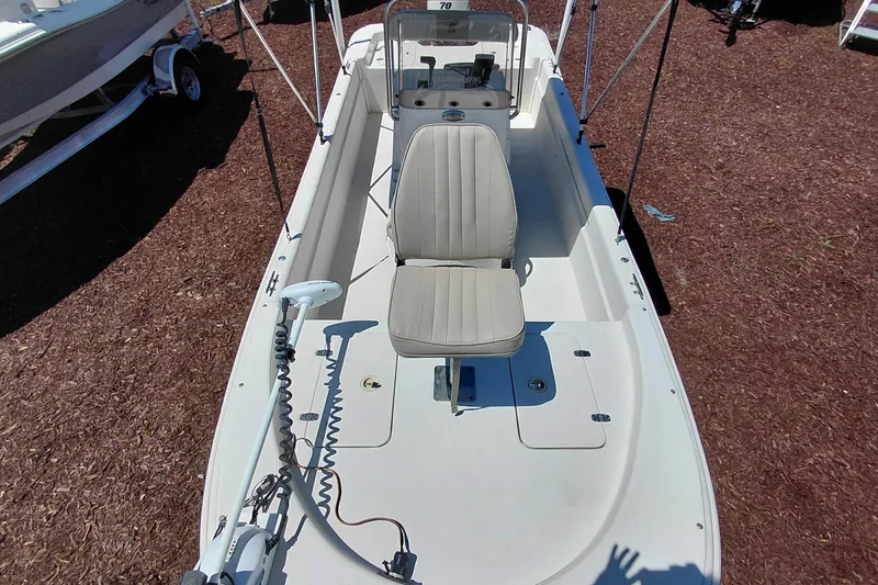 Slide: The Image of 2017 Carolina Skiff 18 JVX CC boat with central console and seating, displayed outdoors. - 10