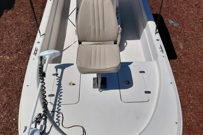 Slide: The Image of 2017 Carolina Skiff 18 JVX CC boat interior with beige seating and trolling motor. - 11