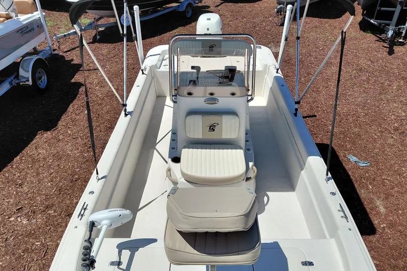 Slide: The Image of 2017 Carolina Skiff 18 JVX CC boat with seating and console, displayed outdoors. - 13