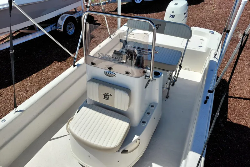 Slide: The Image of 2017 Carolina Skiff 18 JVX CC boat with center console and seating, displayed outdoors. - 15