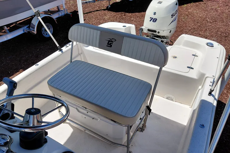 Slide: The Image of 2017 Carolina Skiff 18 JVX CC boat interior with steering wheel and Suzuki 70 outboard motor. - 19