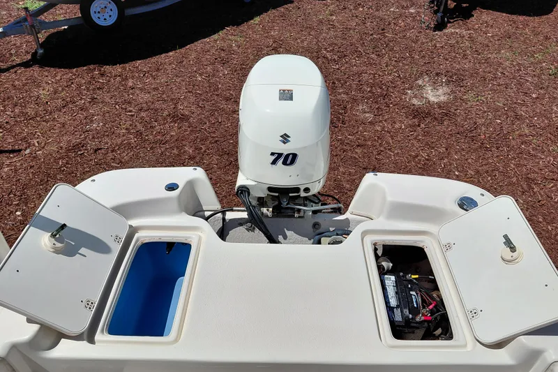 Slide: The Image of 2017 Carolina Skiff 18 JVX CC boat with Suzuki 70 outboard motor and open storage compartments. - 25