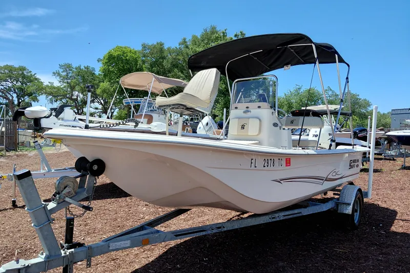 Slide: The Image of 2017 Carolina Skiff 18 JVX CC boat on trailer, parked outdoors under clear sky. - 3