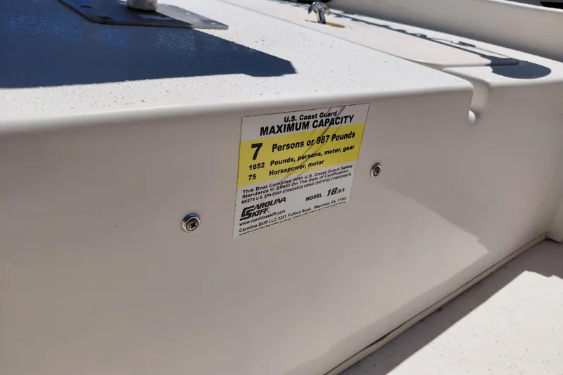 Slide: The Image of 2017 Carolina Skiff 18 JVX CC boat capacity label, showing maximum capacity of 7 persons or 987 pounds. - 31