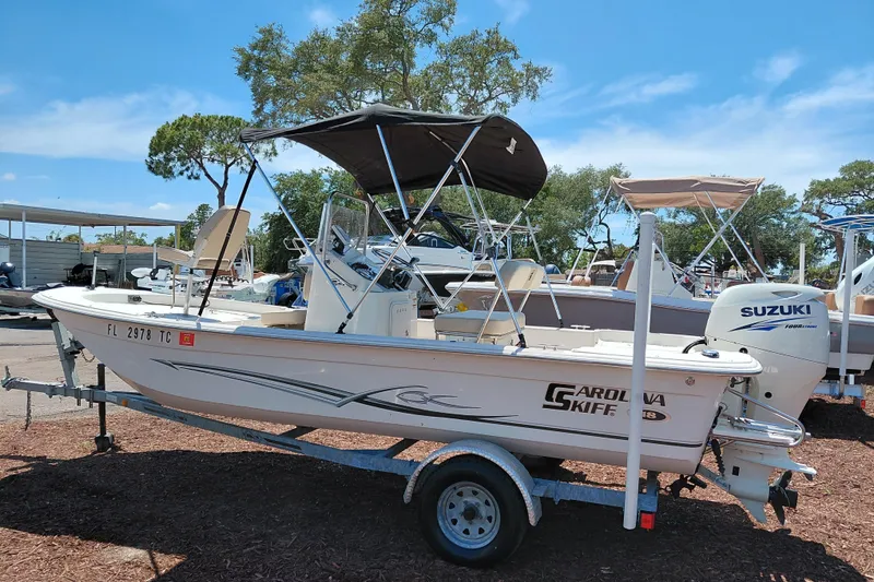 Slide: The Image of 2017 Carolina Skiff 18 JVX CC boat with Suzuki outboard motor on trailer. - 4