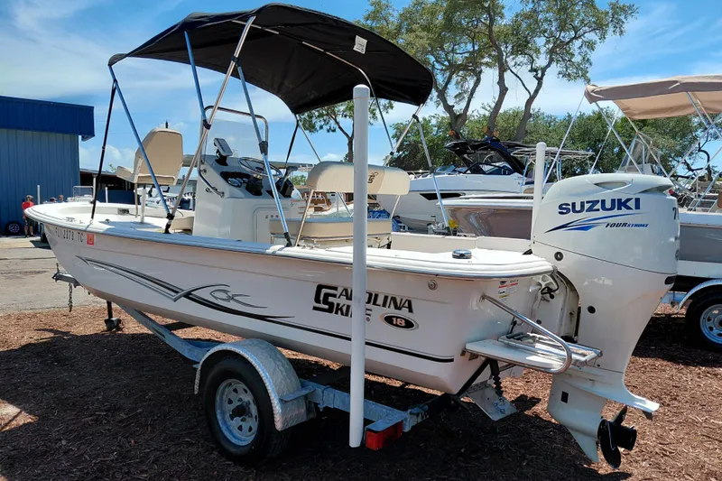 Slide: The Image of 2017 Carolina Skiff 18 JVX CC boat with Suzuki outboard motor on trailer. - 5