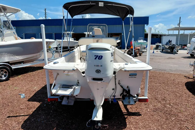 Slide: The Image of 2017 Carolina Skiff 18 JVX CC boat with Suzuki 70 HP outboard motor, docked outdoors. - 6