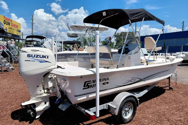 Slide: The Image of 2017 Carolina Skiff 18 JVX CC boat with Suzuki engine on display outdoors. - 8