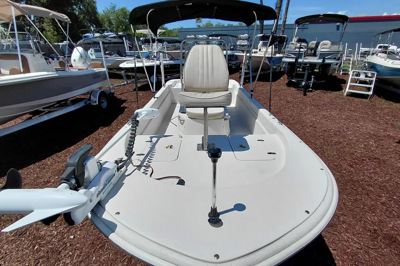 Slide: The Image of 2017 Carolina Skiff 18 JVX CC boat with trolling motor, displayed outdoors. - 9