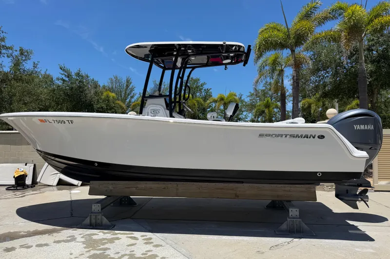 The Image of 2022 Sportsman Heritage 231 Center Console boat on display, featuring Yamaha engine, outdoors. - 0