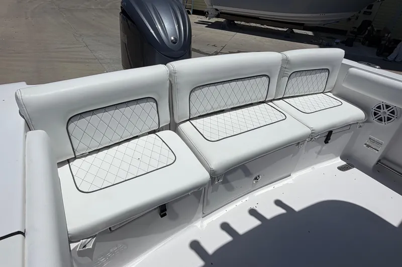 Slide: The Image of 2022 Sportsman Heritage 231 Center Console boat with white cushioned seating and diamond stitching. - 10