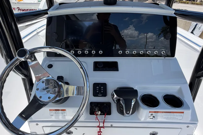 Slide: The Image of 2022 Sportsman Heritage 231 Center Console dashboard with steering wheel and controls. - 13