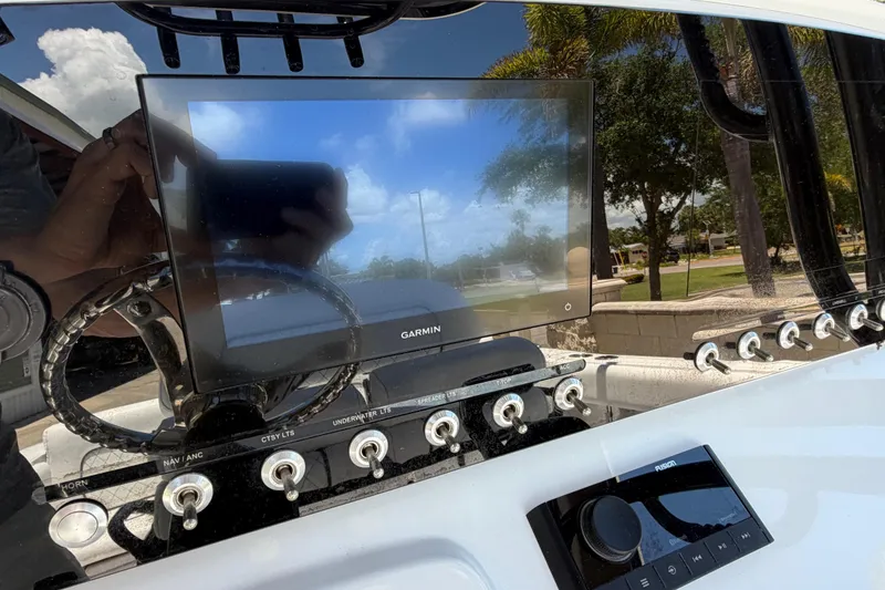 Slide: The Image of 2022 Sportsman Heritage 231 Center Console dashboard with Garmin display and control switches. - 14