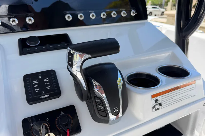 Slide: The Image of Control panel of 2022 Sportsman Heritage 231 Center Console with throttle and cup holders. - 15