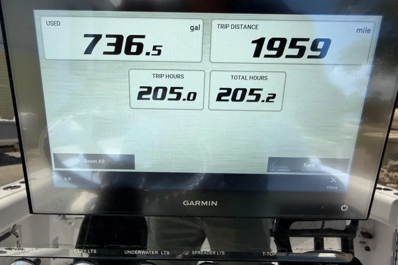 Slide: The Image of Garmin display showing fuel usage, trip distance, and hours on a 2022 Sportsman Heritage 231 Center Console. - 16