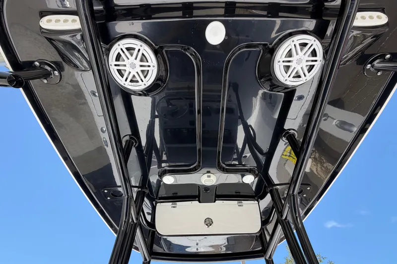 Slide: The Image of 2022 Sportsman Heritage 231 Center Console boat with sleek black T-top and speakers. - 17