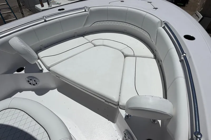 Slide: The Image of 2022 Sportsman Heritage 231 Center Console boat with white cushioned seating area. - 7
