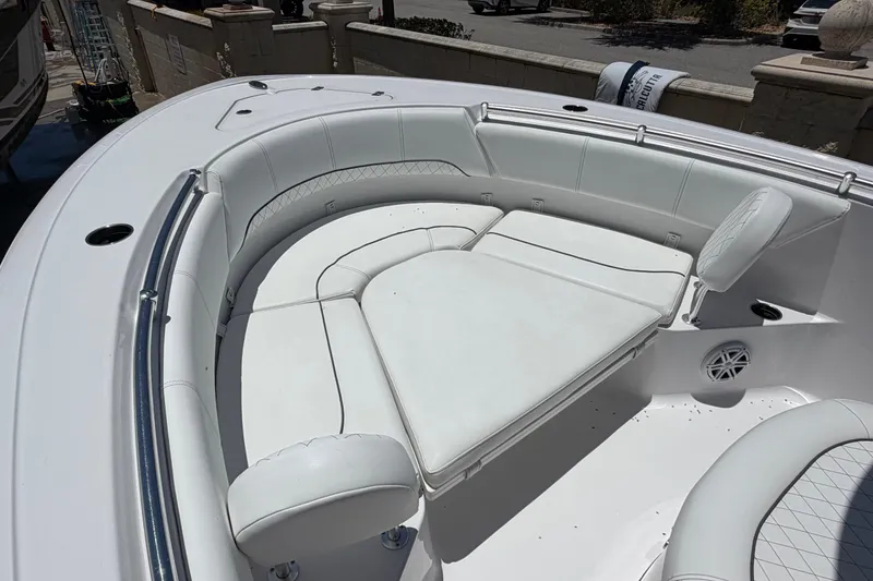 Slide: The Image of 2022 Sportsman Heritage 231 Center Console boat with white cushioned seating area. - 8