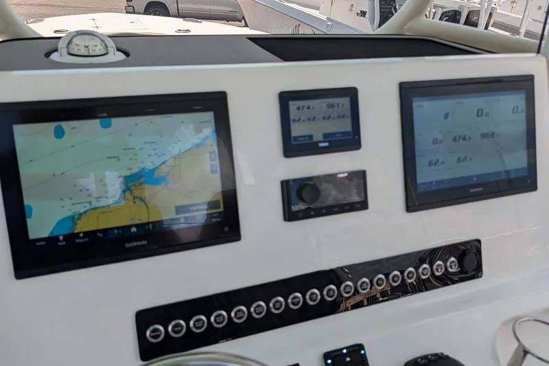 Slide: The Image of 2025 Key West 260 Center Console dashboard with navigation and control screens. - 16