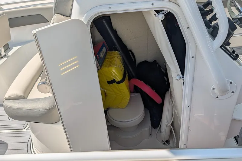 Slide: The Image of 2025 Key West 260 Center Console boat cabin with storage items and seating. - 18