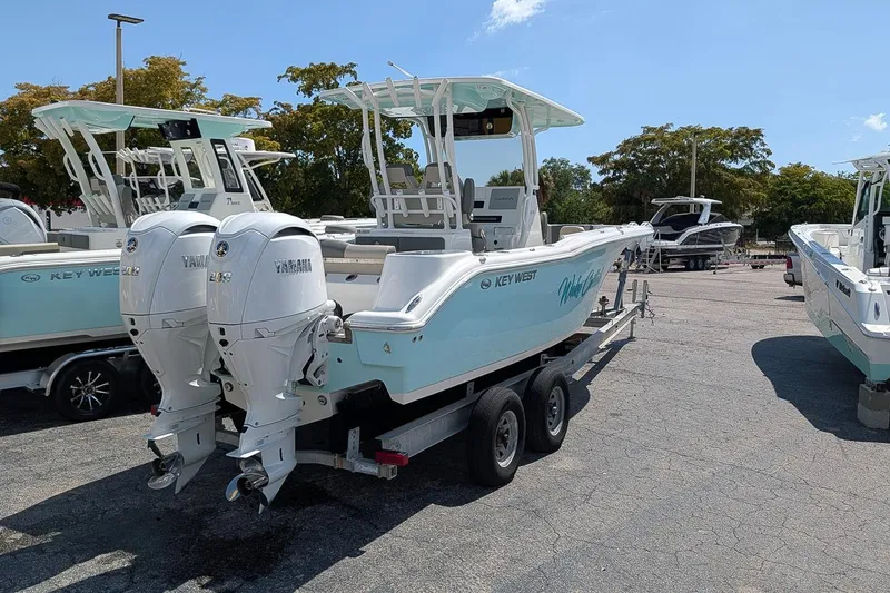 Slide: The Image of 2025 Key West 260 Center Console boat with twin Yamaha engines on a trailer. - 2