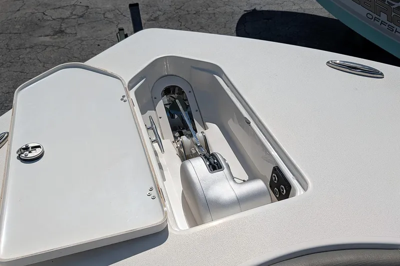Slide: The Image of 2025 Key West 260 Center Console anchor compartment with open hatch on deck. - 22