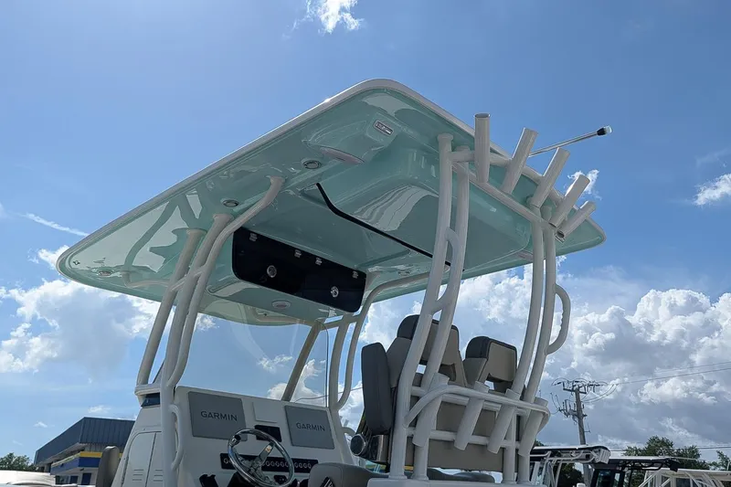 Slide: The Image of 2025 Key West 260 Center Console boat with T-top under a clear blue sky. - 23