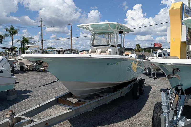 Slide: The Image of 2025 Key West 260 Center Console boat on trailer under a sunny sky. - 4