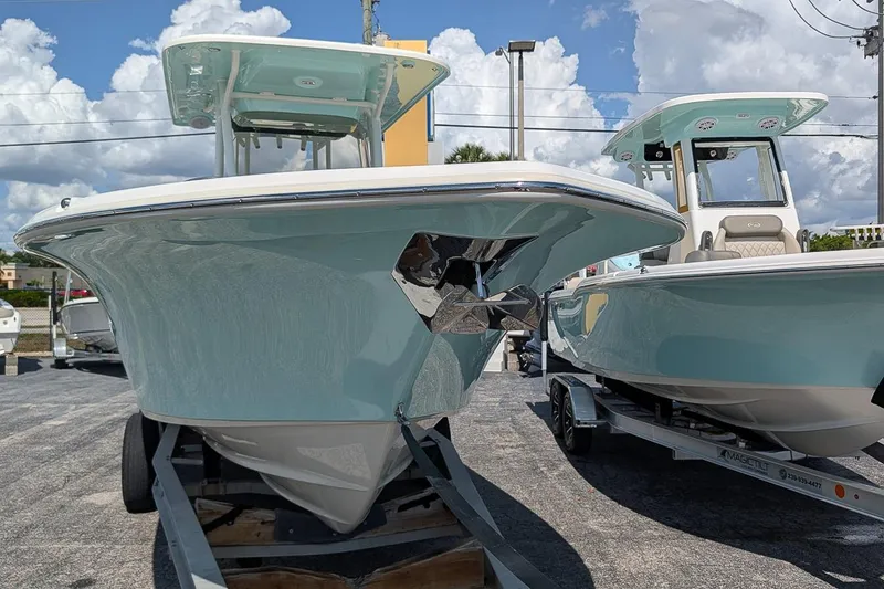 Slide: The Image of 2025 Key West 260 Center Console boats on trailers under a cloudy sky. - 5
