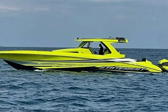The Image of Bright yellow 2026 Statement 47 GTrs boat cruising on open water. - 0