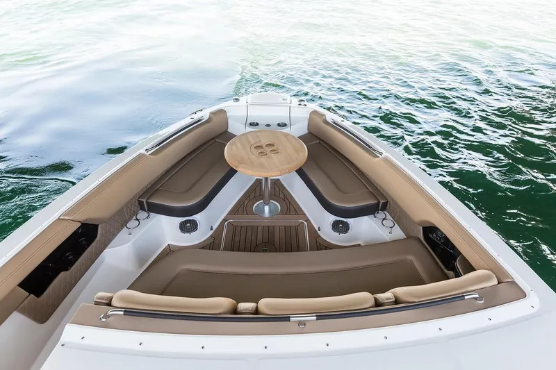 Slide: The Image of Manufacturer Provided Image: 2019 Sea Ray SLX 400 OB boat bow seating area with table on water. - 11