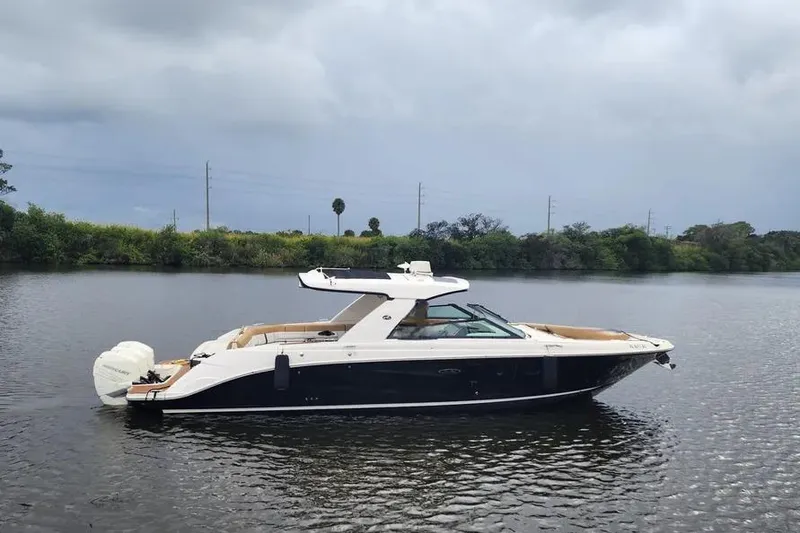 Slide: The Image of 2019 Sea Ray SLX 400 Outboard boat on calm water, overcast sky. - 2